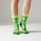 Green socks with avocado and heart patterns on a white background