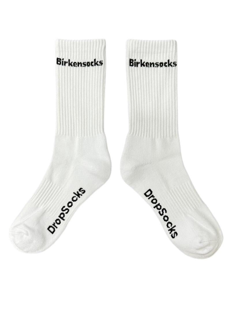 Two white socks with Birkensocks written black text on them